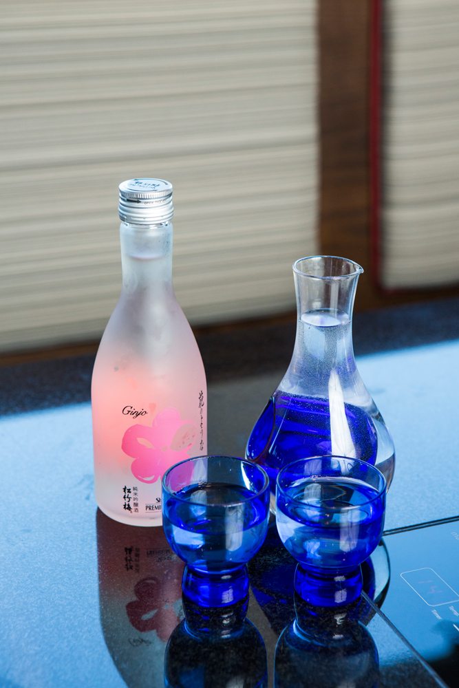 Sake shot glasses, pitcher and bottle.