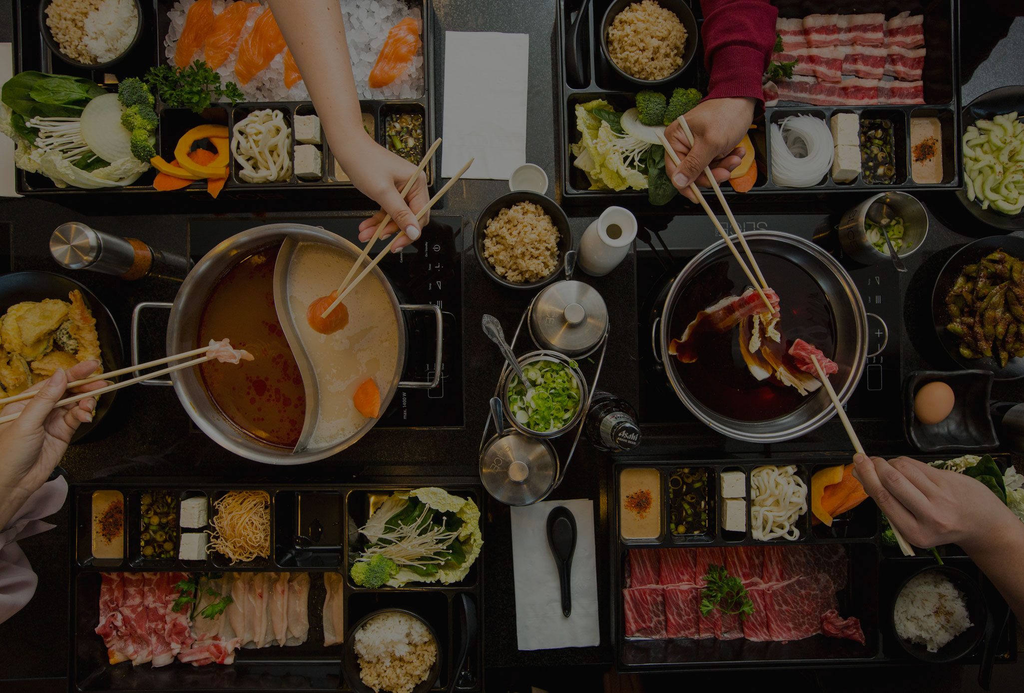 Tinted picture of a table filled with Shabu Shabu